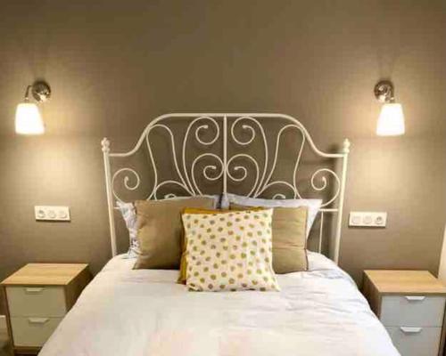 a bedroom with a white bed with two night stands at LA CALLEJINA Cáceres Full equipped HOUSE AT CC-00616 in Cáceres