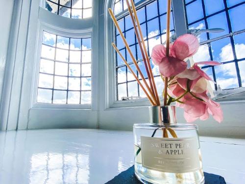 a vase filled with pink flowers sitting on a table at Castle Hotel in Eynsford