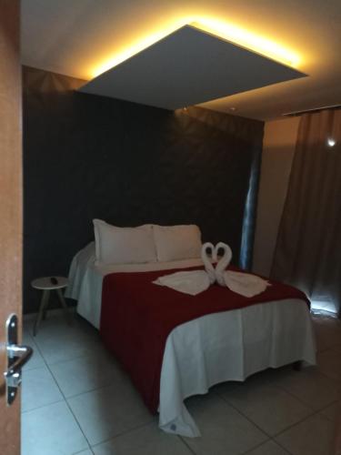 a bedroom with a bed with a ribbon on it at LUZ DO LUAR in Pedra Azul