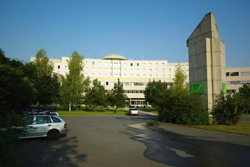 a parking lot in front of a large building at Kolej Akademie in Brno