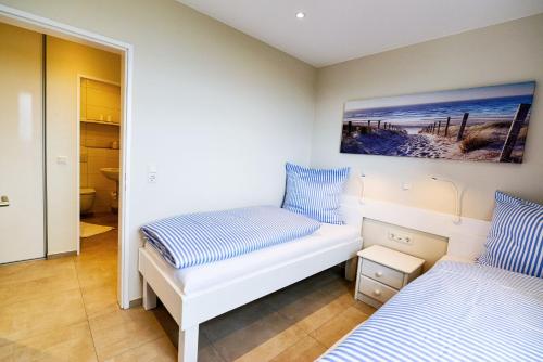 En eller flere senge i et værelse på Strandhochhaus SF07