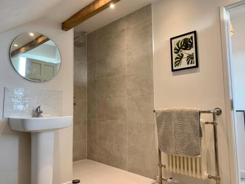 a bathroom with a sink and a mirror at Beautiful sea view, tranquil loft apartment in Lytham St Annes