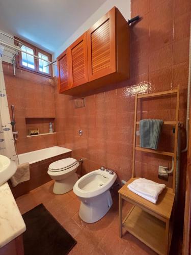 a bathroom with a toilet and a sink at Torri Panoramic Apartment in Torri del Benaco
