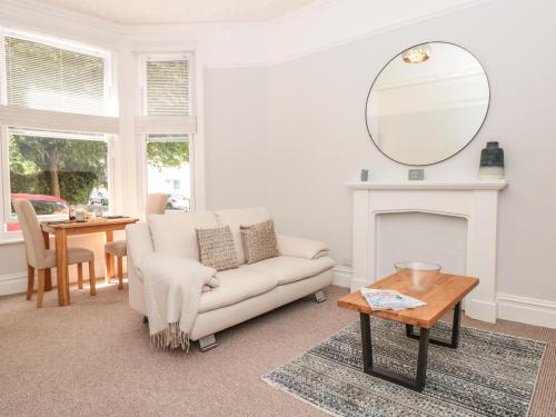 a living room with a couch and a mirror at Flat 1 Byfield in Torquay