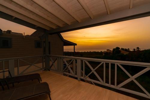 a sunset from the deck of a house at West Rock Villas in Saint James