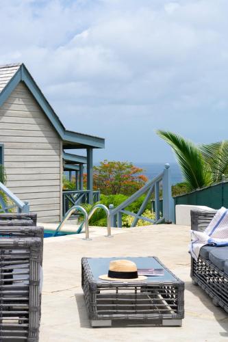 a patio with a table and chairs and a playground at West Rock Villas in Saint James