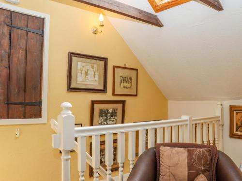a room with a staircase with a chair at Little London in Battle