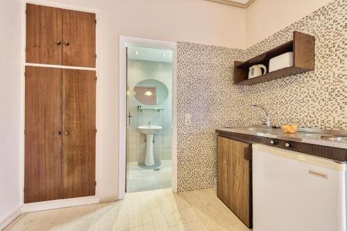 a kitchen with a sink and a toilet in a bathroom at Saint Loukas Studios in Zakynthos