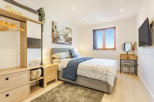 a bedroom with a bed and a mirror at The Belfry in Evesham