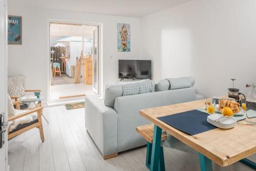 a living room with a couch and a table at Aloha Sands in Camber