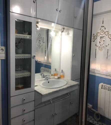 a bathroom with a sink and a mirror at Casa la Torre in Cambados