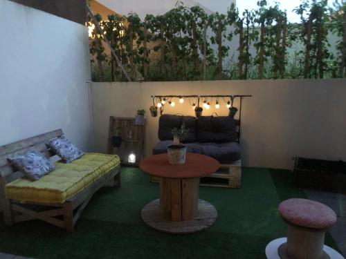 a living room with a couch and a table at Appartement avec terrasse proche de Rennes in Saint-Jacques-de-la-Lande