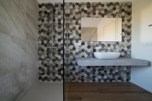 a bathroom with a sink and a mirror at La Promessa in Santa Maria Nuova