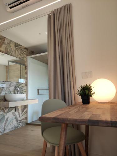 a dining room with a wooden table and green chairs at La Promessa in Santa Maria Nuova