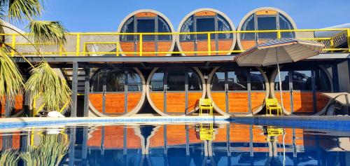 a building with a swimming pool in front of it at ChangoMango in La Ventana