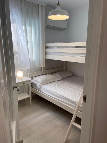a small room with a bunk bed and a window at La Cala Holiday Retreat in La Cala de Mijas