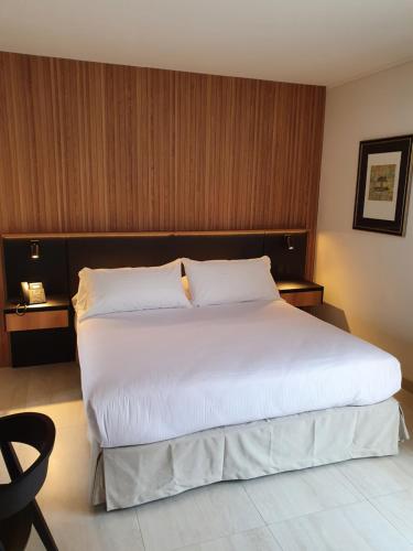 a large white bed in a hotel room at Lastarria Hotel in Santiago