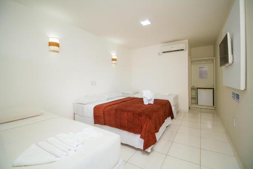 Ліжко або ліжка в номері Na Praia Hotel