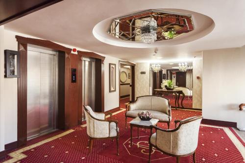 a hotel lobby with chairs and a chandelier at Izmir Palas Hotel in İzmir