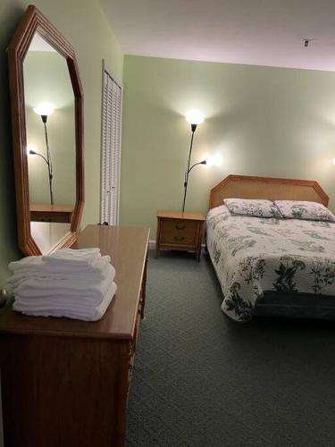 a hotel room with a bed and a mirror at Lovely 2-bedroom condo with pool in Myrtle Beach