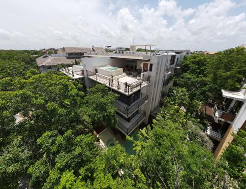 an aerial view of a building in the trees at Casa Wahh in Tulum