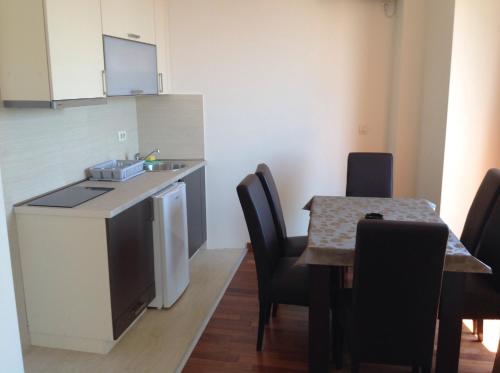 a kitchen and dining room with a table and chairs at Apartments Jelušić in Budva