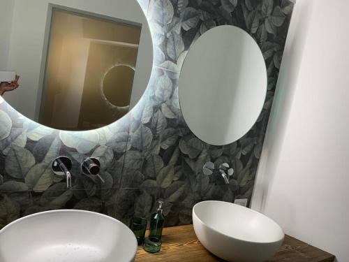 a bathroom with two mirrors and a sink at Anema e Core by Andrea de Carlo in Leverano