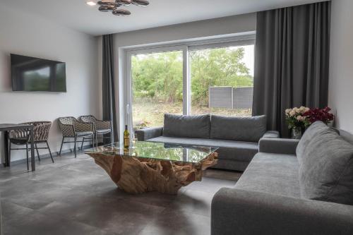 a living room with a couch and a table at Veltlin Bed & Wine in Valtice