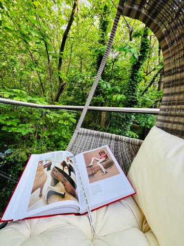 a book sitting on a bed in a gondola at DESIGNER HOUSE - University of Glasgow / Central Glasgow 'Hillhead' West End G12 - Luxurious & Contemporary Detached House / Terrace / Garden / 'electric car charging' Garage Parking in Glasgow