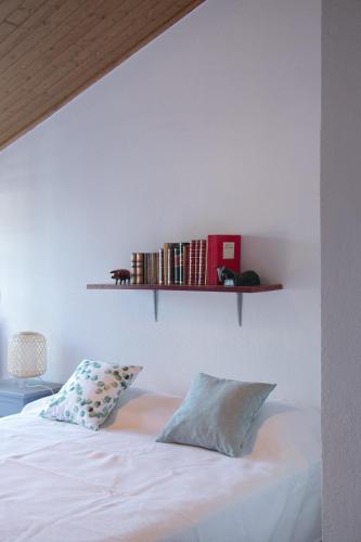 a bedroom with a bed with a shelf on the wall at Quinta de SantAna da Várzea in Abrantes