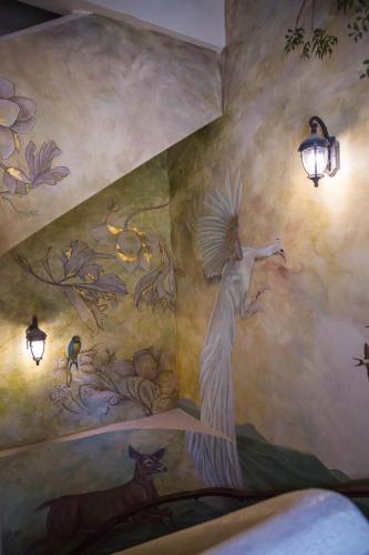 a mural of a peacock on a wall at Hotel Boutique Corazón Mexicano in Guanajuato