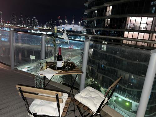 a balcony with a table and a bottle of wine at High Floor Modern 1BR Stunning Views Balcony AC Free Parking in London