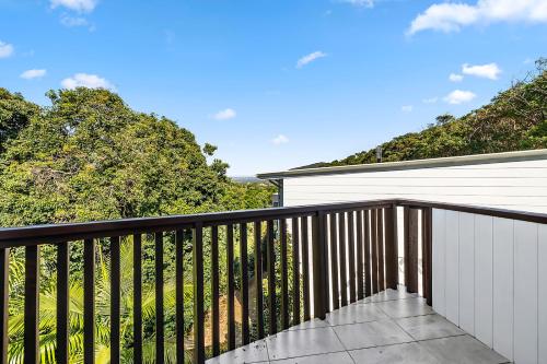 a balcony of a house with trees in the background at Papillon Coolum in Coolum Beach