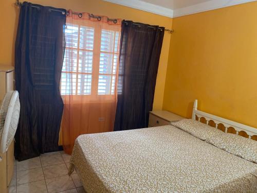 a bedroom with two beds and a window at Finest Accommodation Renfrew Place 4-12 Renfrew Rd 2 bedroom 2 bat Apt # 15 New Kinston Jamaica in Kingston