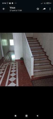a staircase in a building with a stair case at Appartement in Taza