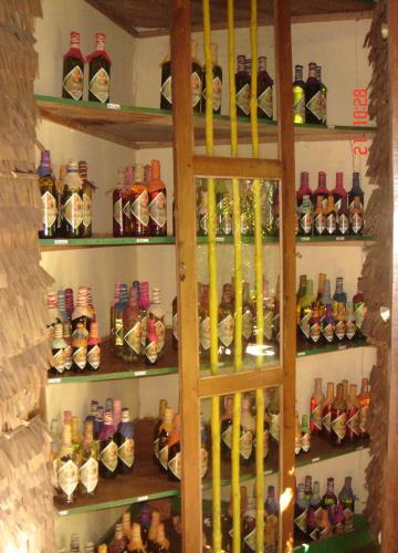 a shelf filled with lots of different types of bottles at Les bungalows d'Ambonara in Hell-Ville
