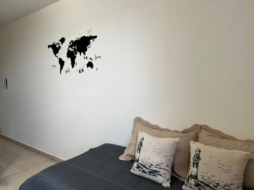 a bedroom with a map of the world on the wall at Departamentos Hipolito Yrigoyen in San Rafael