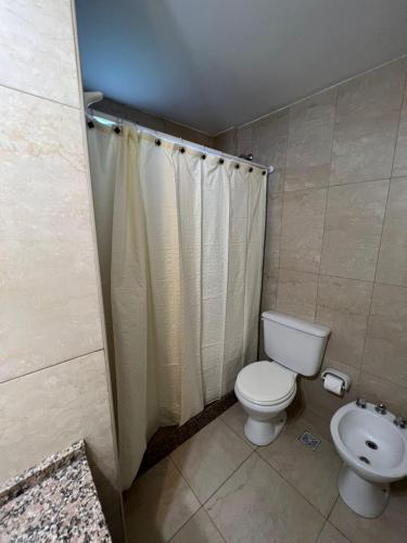 a bathroom with a toilet and a sink at Departamentos Hipolito Yrigoyen in San Rafael