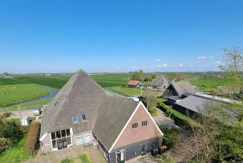 an aerial view of a house with a roof at Bed & Breakfast De Koegang in Zuidermeer