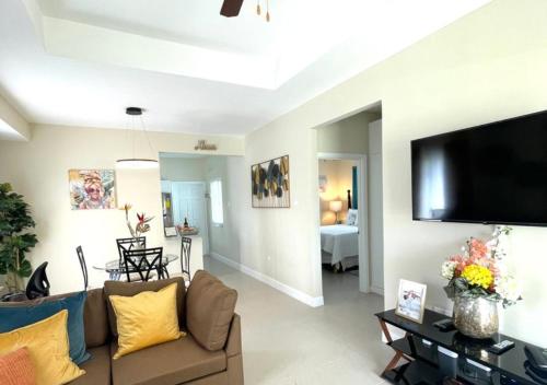 a living room with a couch and a flat screen tv at Seashore Vacation Home, Oceanpointe, Lucea, Jamaica in Point