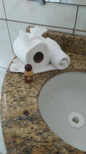a pile of toilet paper sitting on top of a bathroom counter at Hospedaria Ilhéus 03 in Ilhéus