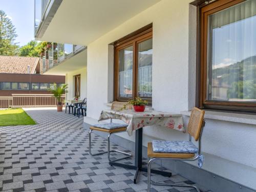 a patio with two chairs and a table and a window at Apartment Claudia in Vandans