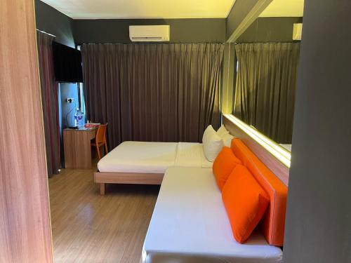 a room with a bed with orange pillows at Azumi Boutique Hotel in Manila