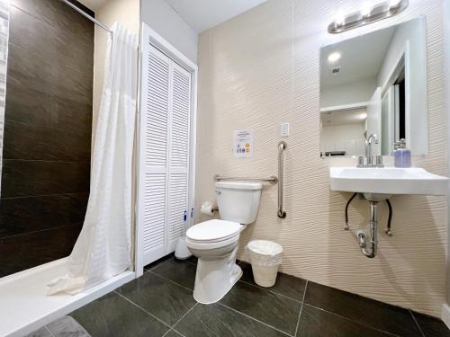 a bathroom with a toilet and a sink and a shower at Stay at Luna on Ridge Ave in Philadelphia