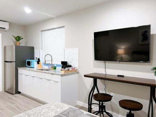 a kitchen with a counter and a television on the wall at Stay at Luna on Ridge Ave in Philadelphia