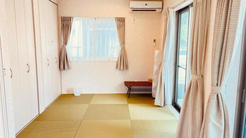 a room with a window and a tiled floor at Blue Ocean in Inbu