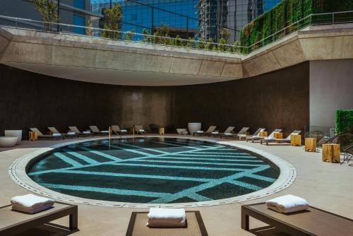 a large swimming pool with chairs in a building at SLS Buenos Aires Puerto Madero in Buenos Aires