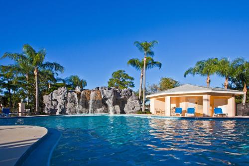 a swimming pool with a waterfall and a resort at Holiday Inn Port St. Lucie, an IHG Hotel in Port Saint Lucie