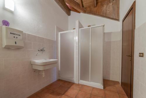 a bathroom with a shower and a toilet and a sink at Rifugio Parpinasca in Trontano