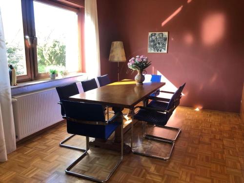 a dining room with a wooden table and chairs at Vast Holiday Home in Frankenau with Infrared Sauna in Frankenau